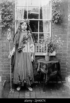 An early 20th century Edwardian black and white photograph of a young English girl dressed in fancy dress costume Stock Photo