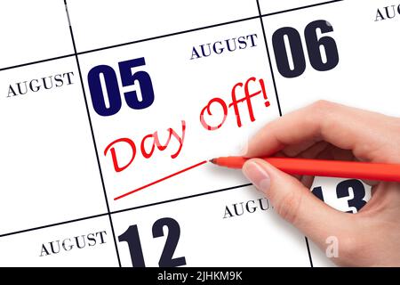 5th day of August. Hand writing text DAY OFF and drawing a line on calendar date 5 August. Vacation planning concept. Summer month, day of the year co Stock Photo