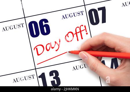 6th day of August. Hand writing text DAY OFF and drawing a line on calendar date 6 August. Vacation planning concept. Summer month, day of the year co Stock Photo