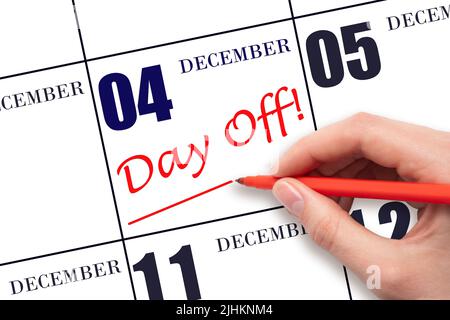 4th day of December. Hand writing text DAY OFF and drawing a line on calendar date 4 December. Vacation planning concept. Winter month, day of the yea Stock Photo
