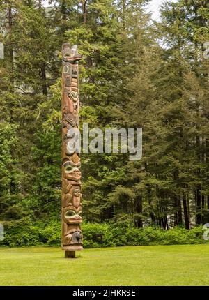 Sitka, AK - 8 June 2022: Totem poles displayed in the Sitka National Historical park in Alaska Stock Photo