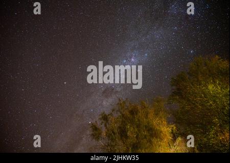 Milky Way shines over a mountain in the desert in Namibia Stock Photo