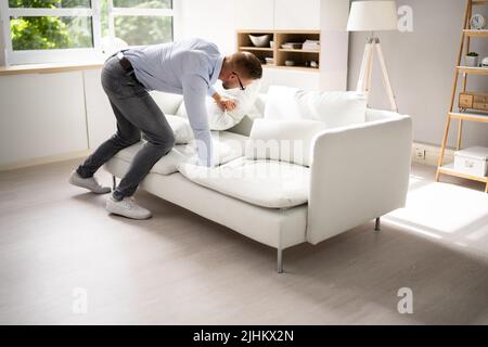 Man Looking For Lost Keys Or Searching Something Stock Photo