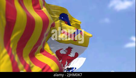 The region flag of Provence-Alpes-Côte d'Azur waving in the wind on a clear day. Provence-Alpes-Côte d'Azur is one of the eighteen administrative regi Stock Photo