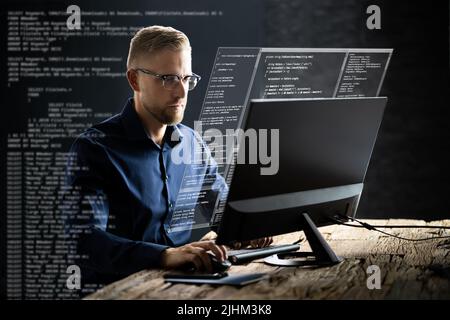 Computer Programmer Writing Program Code On Computer In Office Stock Photo