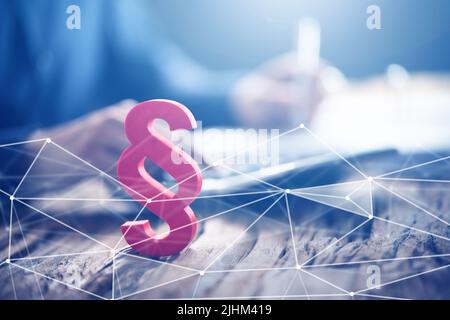 Close-up Of A Red Paragraph Symbol In Front Of Person Working At Workplace Stock Photo