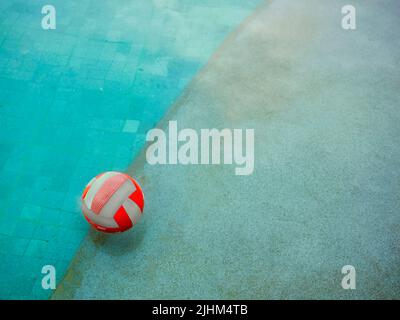 A Water volleyball floating on water in the swimming pool in a rainy day Stock Photo