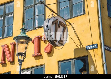 Colorful facade of traditional house and old ships along the Nyhavn Canal or New Harbour, 17th-century waterfront, canal and entertainment district Stock Photo