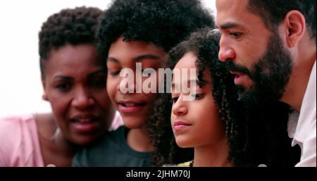 Happy multiracial family using smartphone Stock Photo