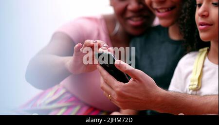 Happy multiracial family using smartphone Stock Photo
