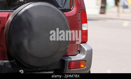 Spare wheel of a car in a case close-up, modern car rear view Stock Photo