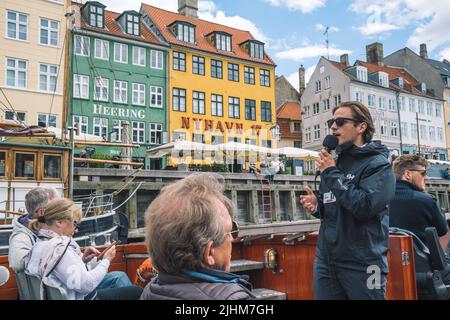 Colorful facade of traditional houses and old ships along the Nyhavn Canal or New Harbour, 17th-century waterfront, view from a cruise boat Stock Photo