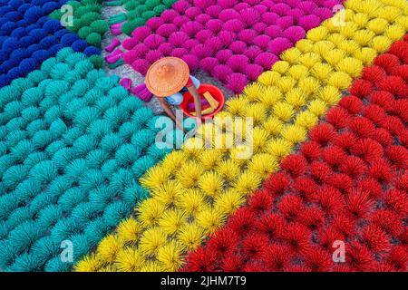 Workers crafting colorful plastic straws from pipes—pattern, texture, bright colors, labor, industry, reuse, straw making, plastic process Stock Photo