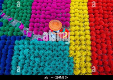 Workers crafting colorful plastic straws from pipes—pattern, texture, bright colors, labor, industry, reuse, straw making, plastic process Stock Photo