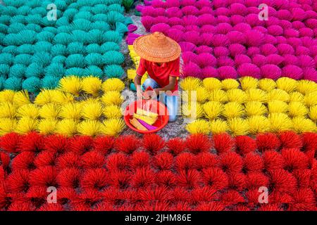 Workers crafting colorful plastic straws from pipes—pattern, texture, bright colors, labor, industry, reuse, straw making, plastic process Stock Photo