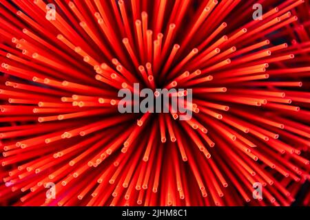 Workers crafting colorful plastic straws from pipes—pattern, texture, bright colors, labor, industry, reuse, straw making, plastic process Stock Photo
