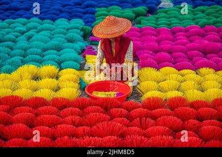 Workers crafting colorful plastic straws from pipes—pattern, texture, bright colors, labor, industry, reuse, straw making, plastic process Stock Photo