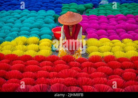 Workers crafting colorful plastic straws from pipes—pattern, texture, bright colors, labor, industry, reuse, straw making, plastic process Stock Photo