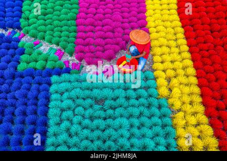 Workers crafting colorful plastic straws from pipes—pattern, texture, bright colors, labor, industry, reuse, straw making, plastic process Stock Photo
