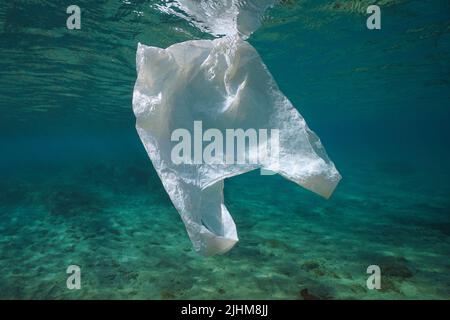 A white plastic bag underwater, plastic waste pollution in the oceans Stock Photo