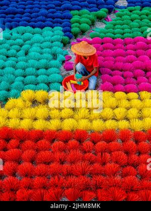 Workers crafting colorful plastic straws from pipes—pattern, texture, bright colors, labor, industry, reuse, straw making, plastic process Stock Photo