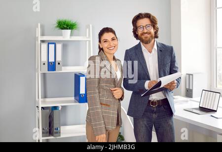 Team of two happy successful young business people working in their modern office Stock Photo