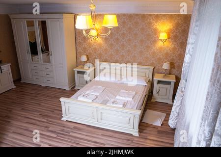 luxury room with vintage wallpaper and a double bed. fresh bed linen. view from above. Stock Photo