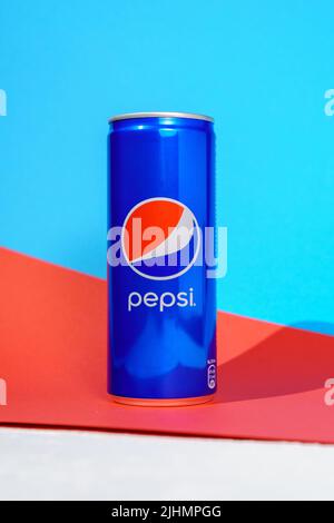 Tyumen, Russia-June 30, 2022: Pepsi drink in a can colorful background. Pepsi is carbonated soft drink produced by PepsiCo. Vertical photo Stock Photo