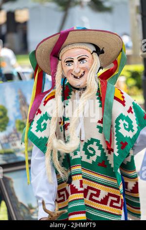 A young Mexican boy, dressed in an old man costume, performs the traditional Danza de los Viejitos at the Plaza Vasco de Quiroga town square, April 11, 2022 in Patzcuaro, Michoacan, Mexico. Stock Photo
