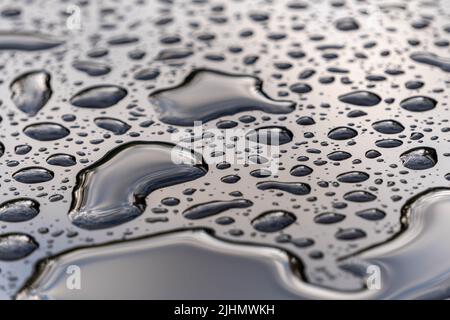 water drops on a black glass surface Stock Photo
