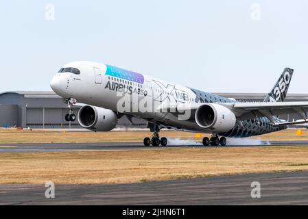 Airbus A350 airliner jet plane landing after display at the Farnborough International Airshow 2022. A350 900 test aircraft. Touching down on runway Stock Photo