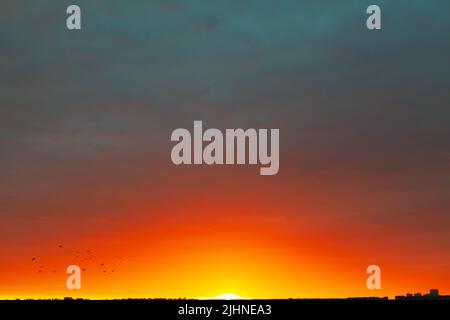 Multicolored heaven with dusk over the city . Vibrant colors sky Stock Photo