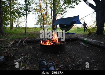 Relaxing by the camp fire on Oak Island in the Apostle Islands National Lakeshore in Lake Superior. Stock Photo