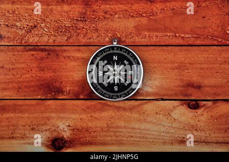 Navigation compass on wooden table background Stock Photo