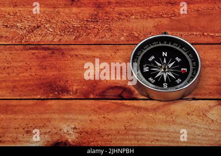 Navigation compass on wooden table background Stock Photo
