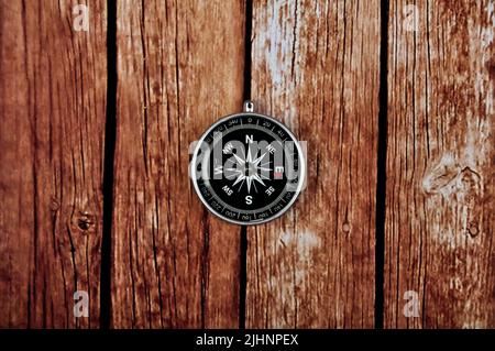 Navigation compass on wooden table background Stock Photo