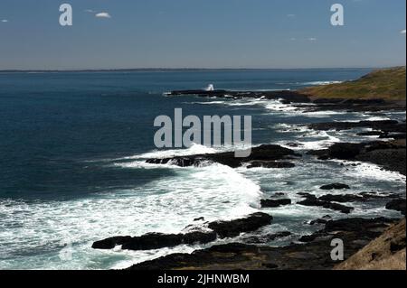 The rocky coast of Phillip Island in Victoria, Australia, looking out across Westernport Bay.The island does have some popular, sandy beaches. Stock Photo