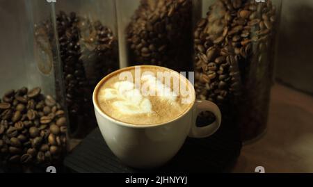 Cappuccino style in a coffee shop with coffee beans Stock Photo