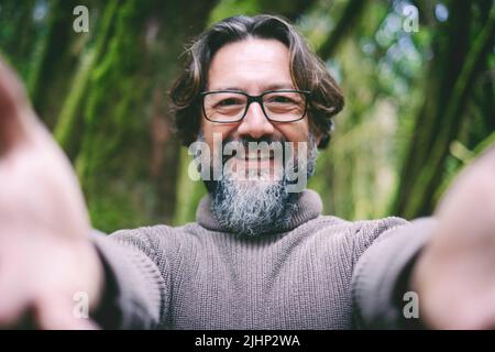 Pov point of view of man opening arms to hug and embrace you. People and love concept. Green nature park in background. Happiness and care. Bearded an Stock Photo