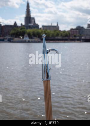 close up of a new silver plated boat hook with wooden stick Stock Photo