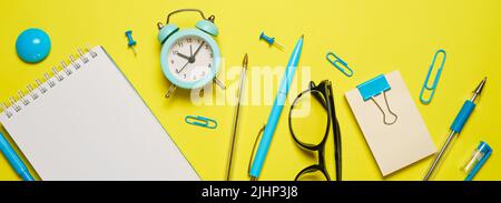 Notebook on a spring for notes and stationery lie on a yellow background, the concept of back to school, colorful school supplies Stock Photo