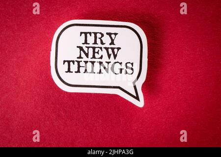 Try New Things. Speech bubble with text on red background. Stock Photo
