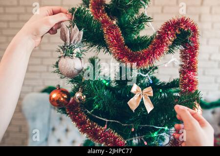 Cute tiny golden bow on Christmas tree Stock Photo