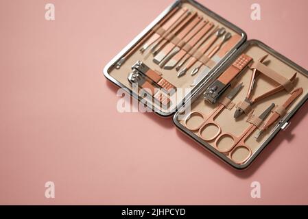 Pastel cosmetic set for nail care in a case placed on a pink background Stock Photo