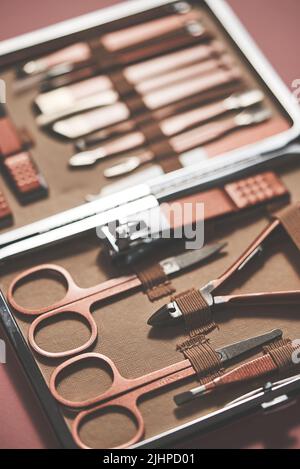 Pastel cosmetic set for nail care in a case placed on a pink background Stock Photo