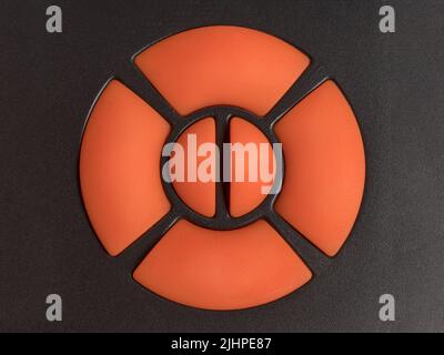 Orange four way joystick switch on black plastic background. Abstract control panel with copy space on the buttons Stock Photo