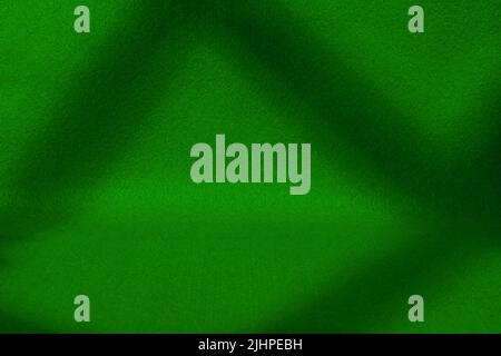Dark green felt covered scene with deep shadows. Texture and background with copy space Stock Photo