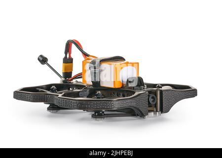 Black FPV cinewhoop drone with battery front view with selective focus. Isolated on white, clipping path included Stock Photo