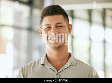 Happy hispanic business man entrepreneur startup owner standing in office looking at camera. Smiling young designer posing in work space Stock Photo
