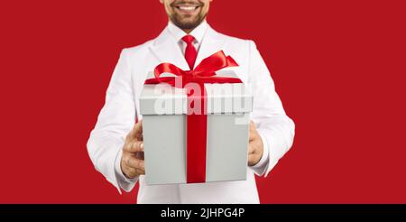 Banner of man in suit present wrapped gift box Stock Photo